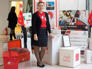 Lady standing with AGS removal boxes and crates around