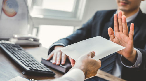 Man declining bribe during an meeting