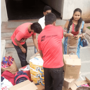 AGS Movers Hyderabad handing out donations to flood victims in Kerala region.