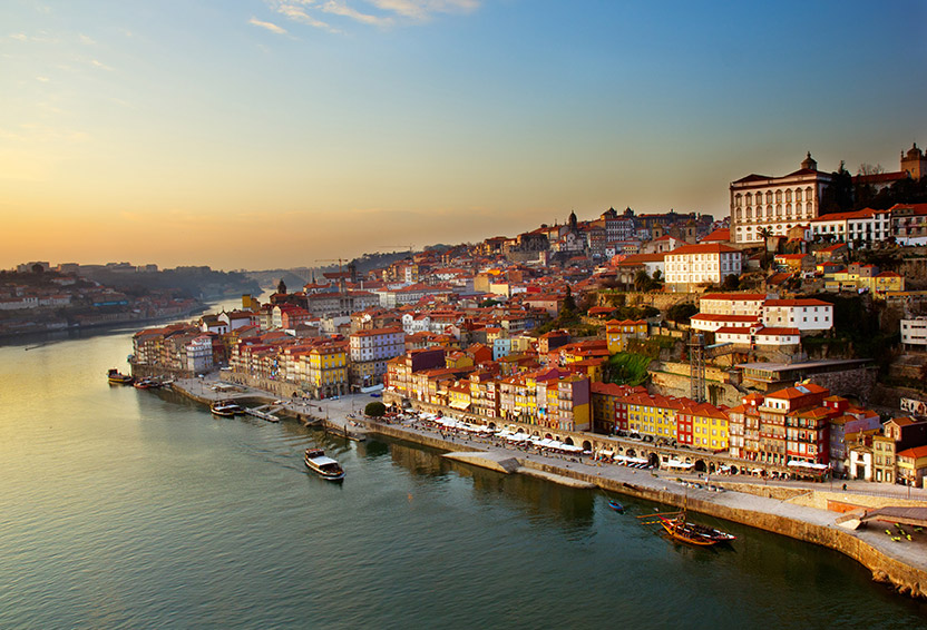 A charming, sun-drenched town in Portugal nestled along the water, reflecting the relaxed coastal lifestyle that attracts expats.